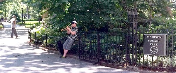 man playing trumpet in Madison Square park, New York City