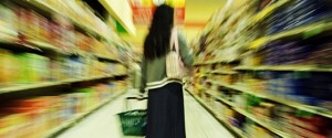 artsy picture of woman overwhelmed in supermarket aisle