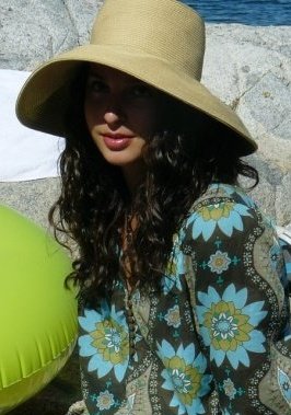 Brichelle Brucker in a large hat and a flowered shirt