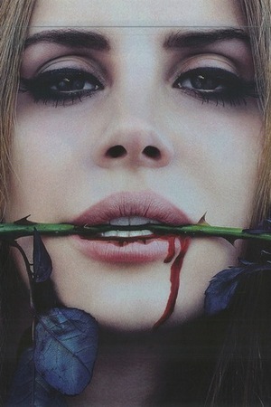 Lana Del Rey biting on a rose